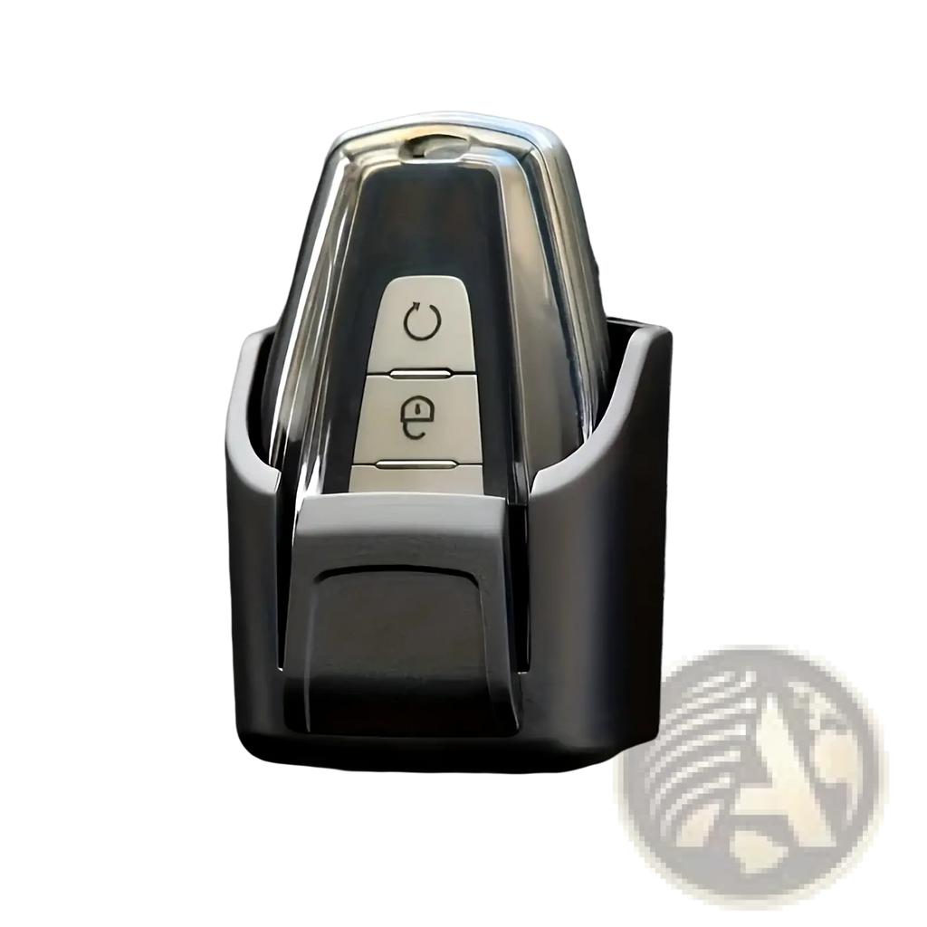 A sleek chrome car key fob with two buttons secure in a black plastic car key organizer dashboard storage box