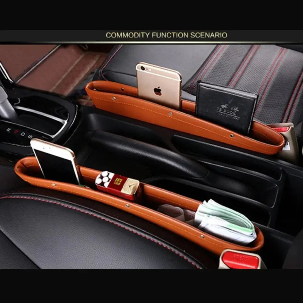 Brown leather car seat gap organizer with red stitching rivets and multiple compartments for center console storage