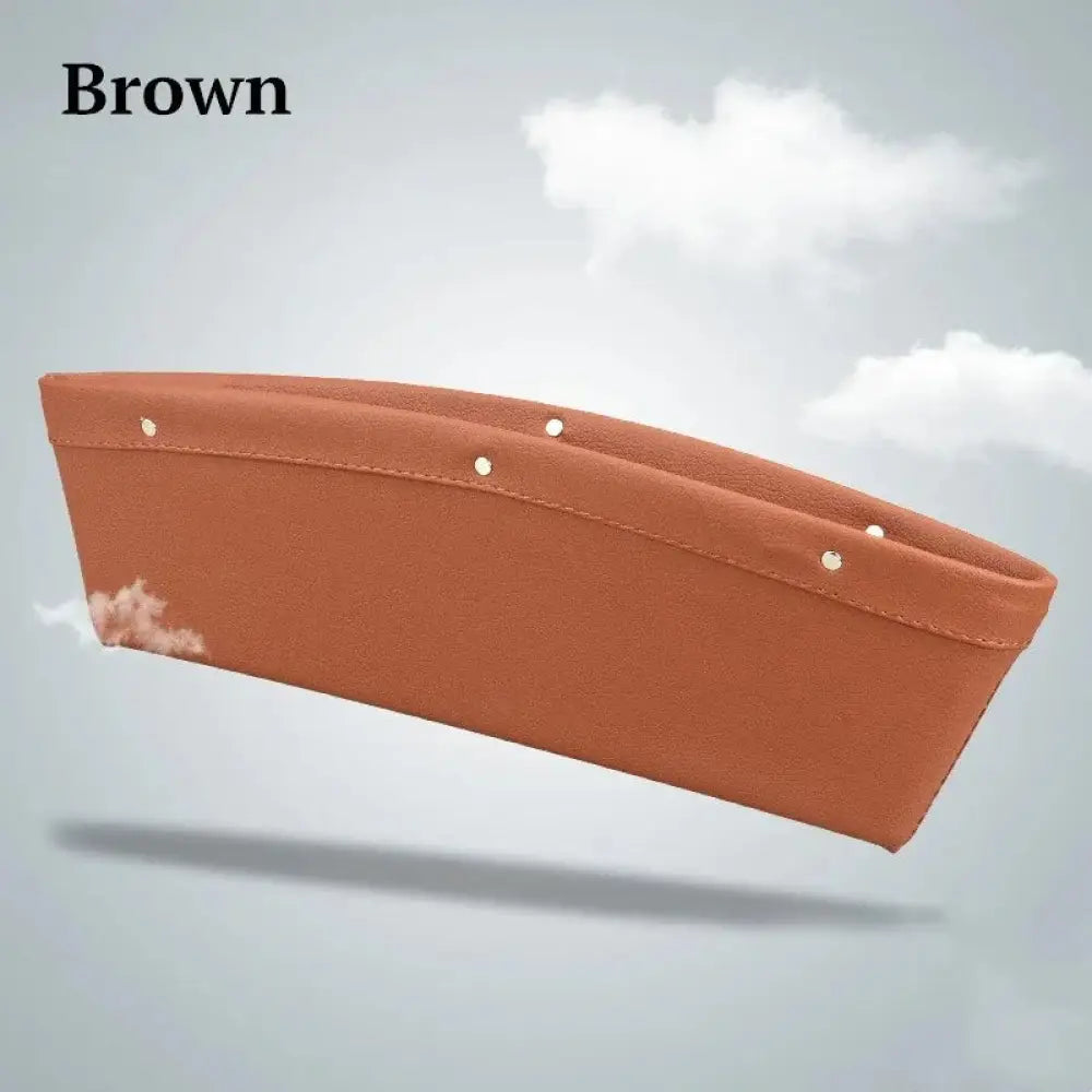 Premium pu leather car seat gap organizer in brown with stitched edges and metallic rivets for efficient storage