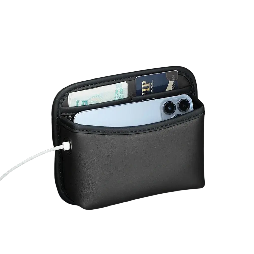 Black faux leather car storage pocket organizer with multiple compartments holding phone cards and cash