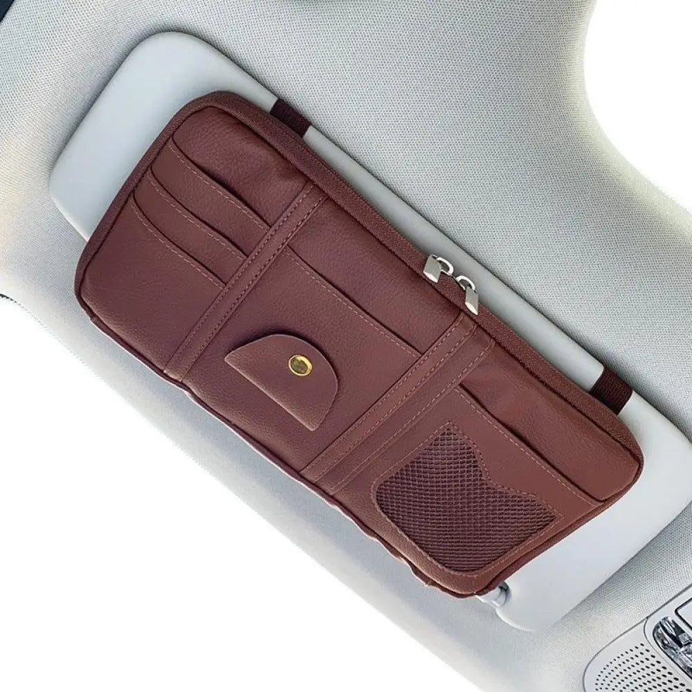 Premium leather car sun visor storage organizer in brown with multiple card slots, mesh pocket, and silver zipper pulls