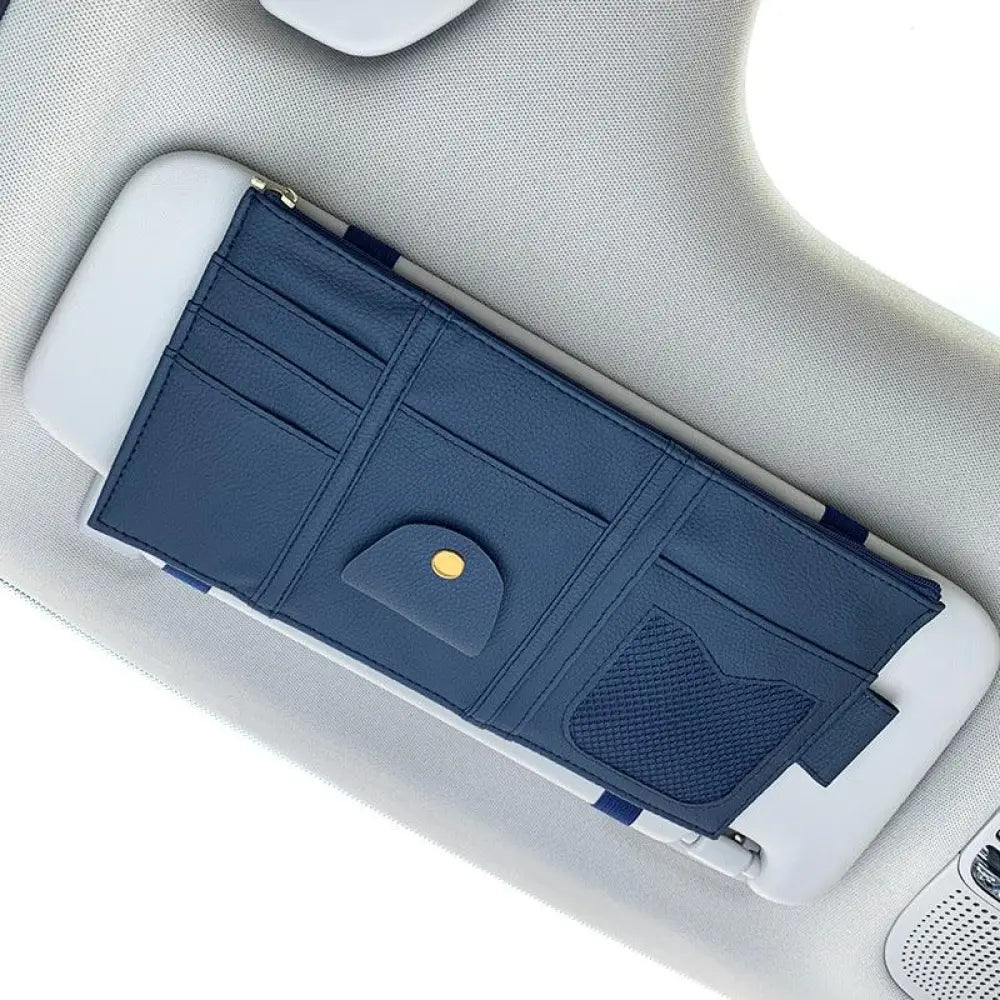 Premium leather car sun visor storage organizer in dark blue with multiple card slots textured pocket and gold-tone snap button