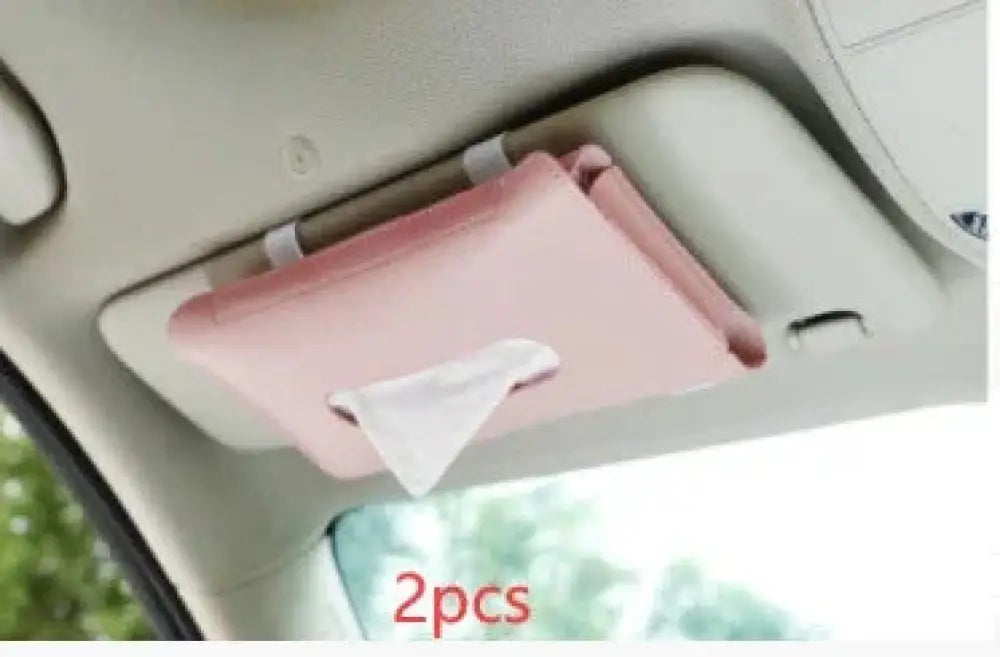 Premium leather car sun visor tissue box holder in pink fabric mounted on a car sun visor for convenient access