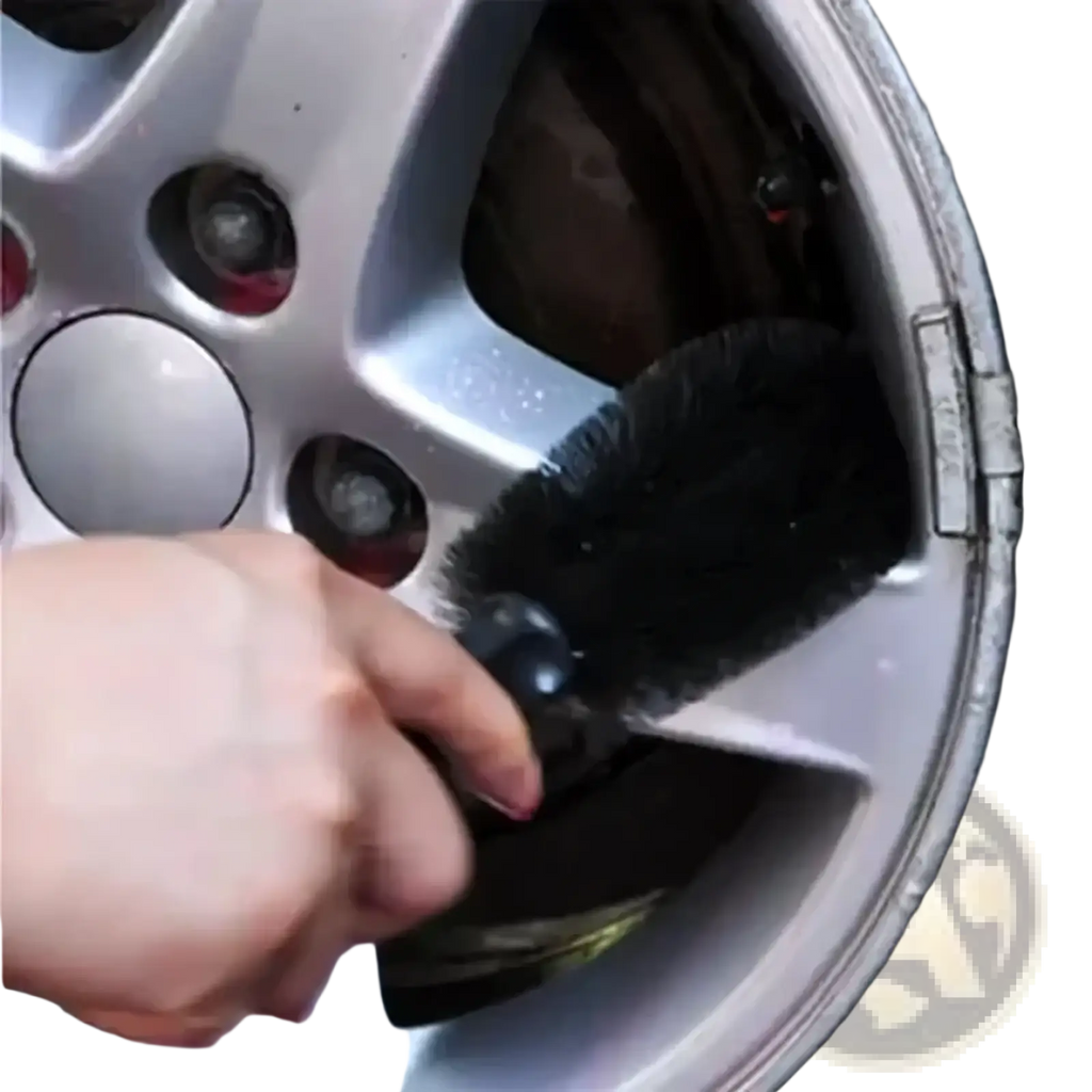 Black bristle wheel brush with black handle cleaning silver alloy car wheel spokes in car washing kit and detailing brush set