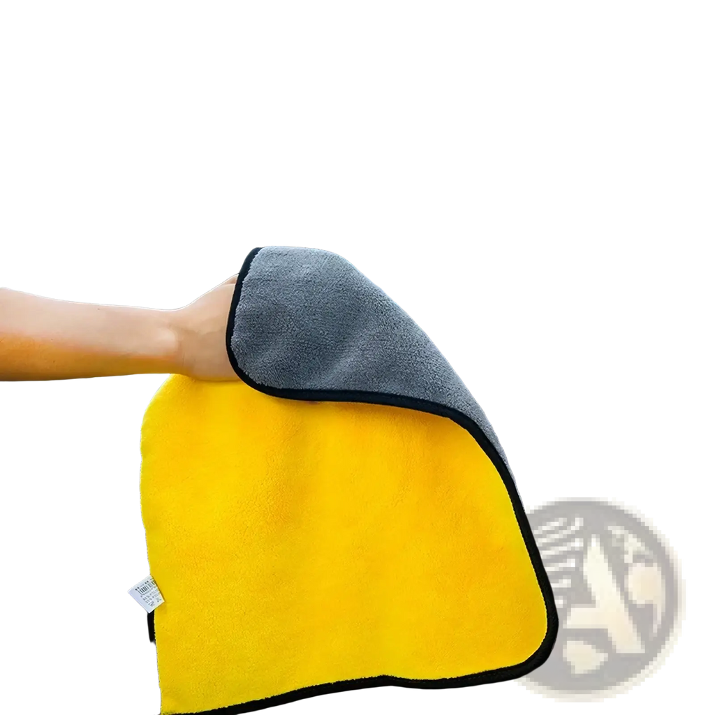 Bright yellow microfiber car cleaning cloth with gray side and black trim from car washing kit and detailing brush set