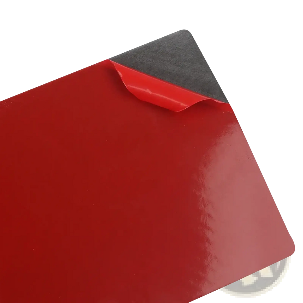 Red glossy adhesive backing sheet showing the back side of carbon fiber cup holder trim for Audi Q7 2007-2015