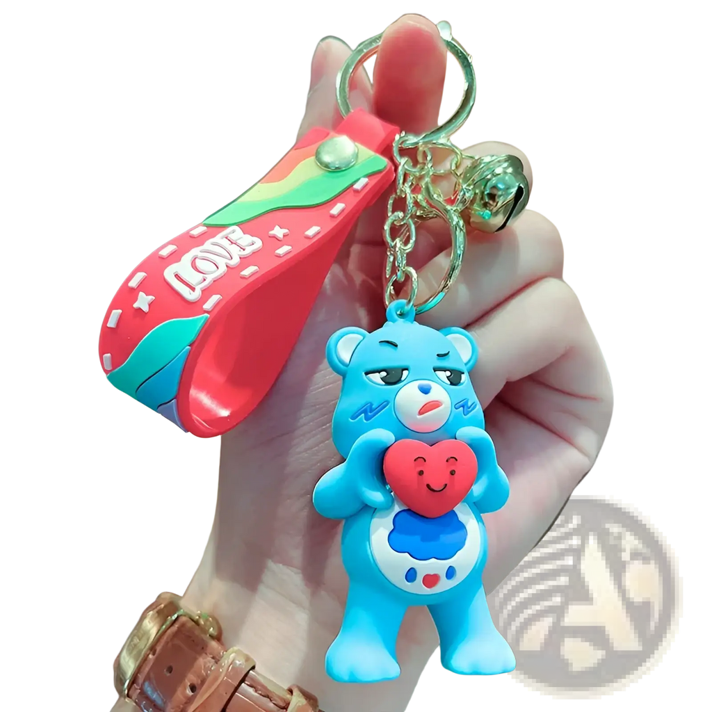A blue silicone Care Bears keychain with a red heart attached to a rainbow-colored strap and chain backpack pendant