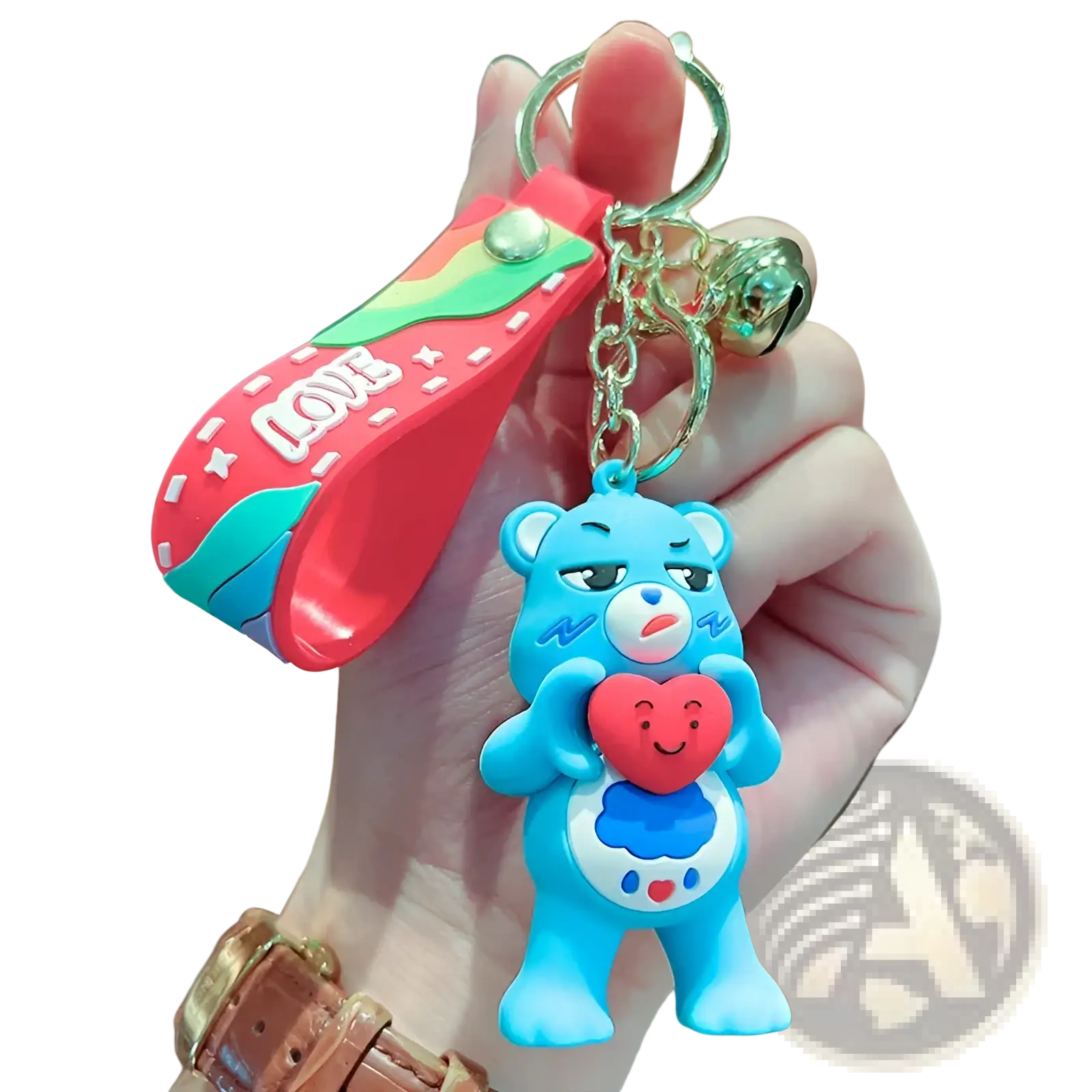 A blue silicone Care Bears keychain with a red heart attached to a rainbow-colored strap and chain backpack pendant