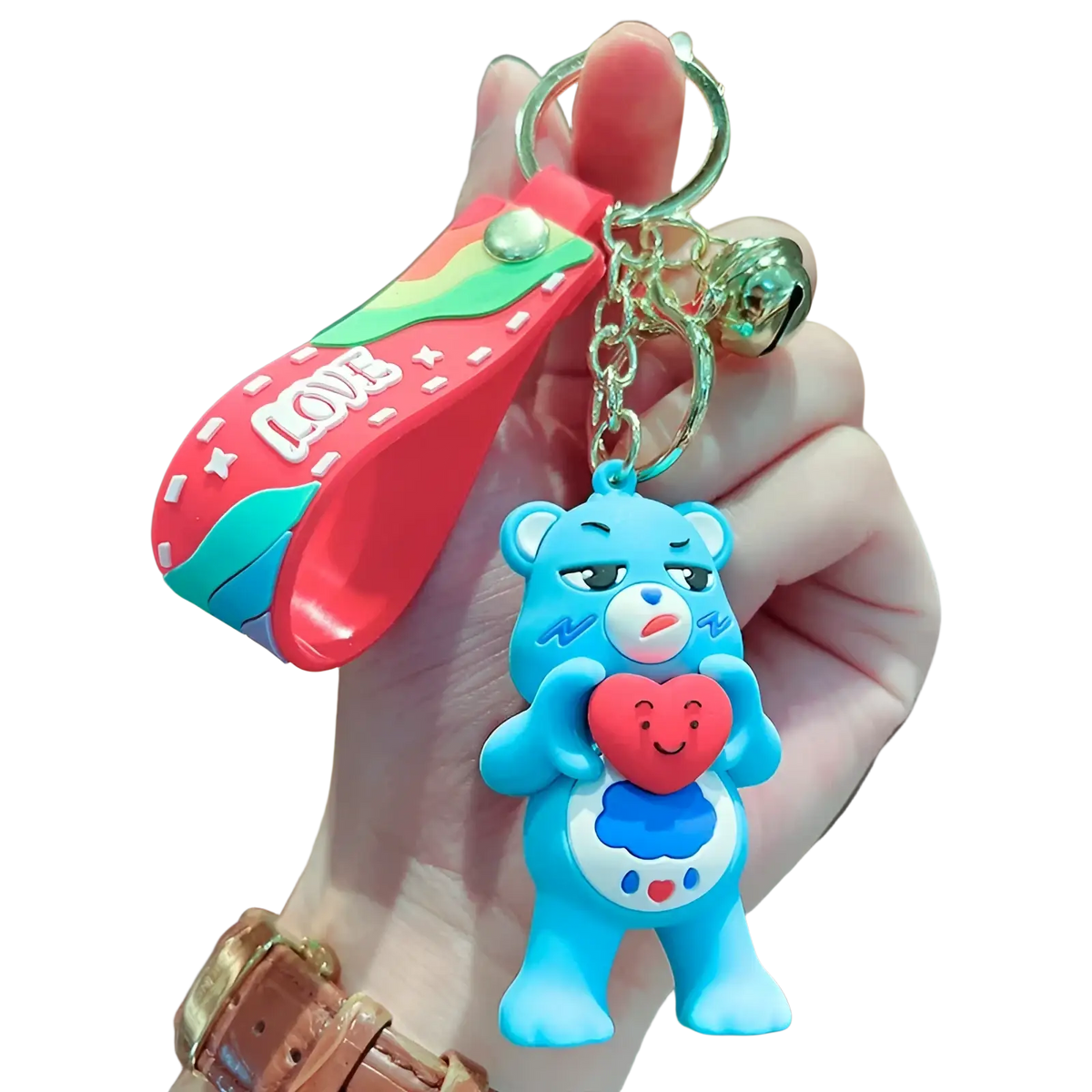 A blue silicone Care Bears keychain with a red heart attached to a rainbow-colored strap and chain backpack pendant