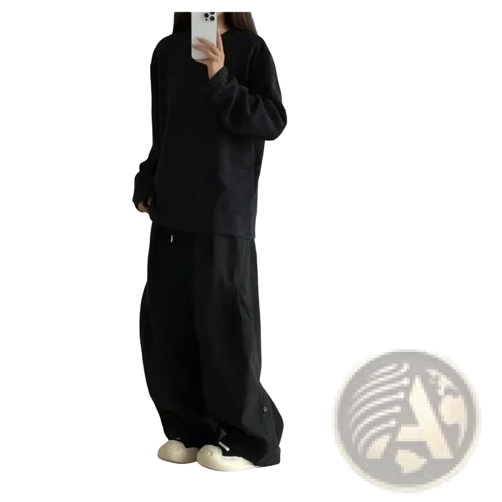 Black oversized long-sleeve top with relaxed fit and subtle texture paired with olive green twill cargo pants for men