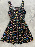 Black sleeveless cotton fit and flare mini dress with vibrant retro carousel and flamingo print on black background