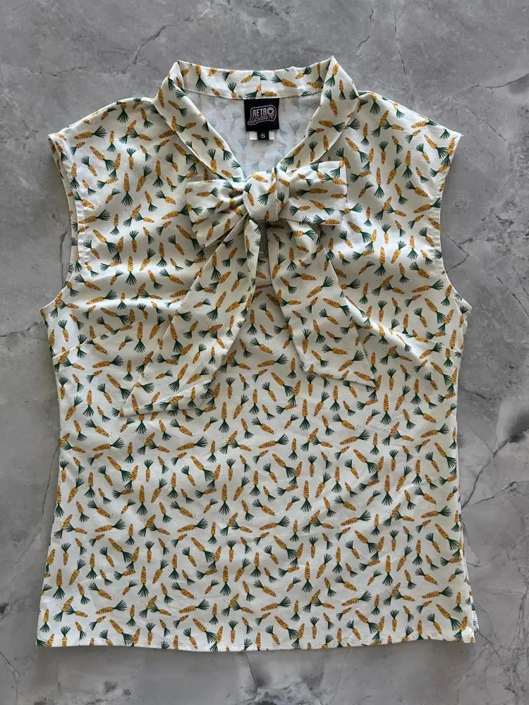 Vintage 1950s style sleeveless cream blouse with orange and green carrot print and a large bow neckline