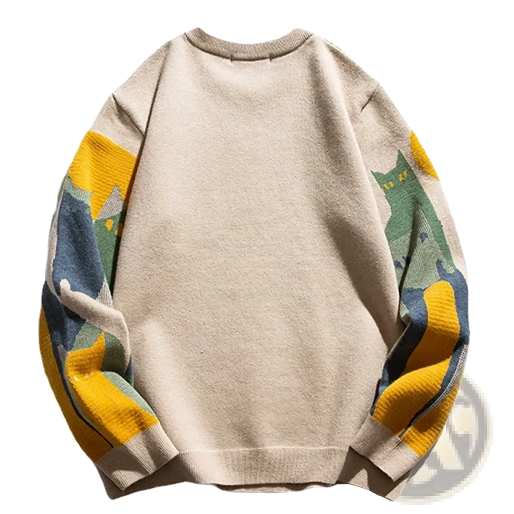 Beige oversized knit sweater featuring colorful cartoon cat and mountain pattern on the sleeves