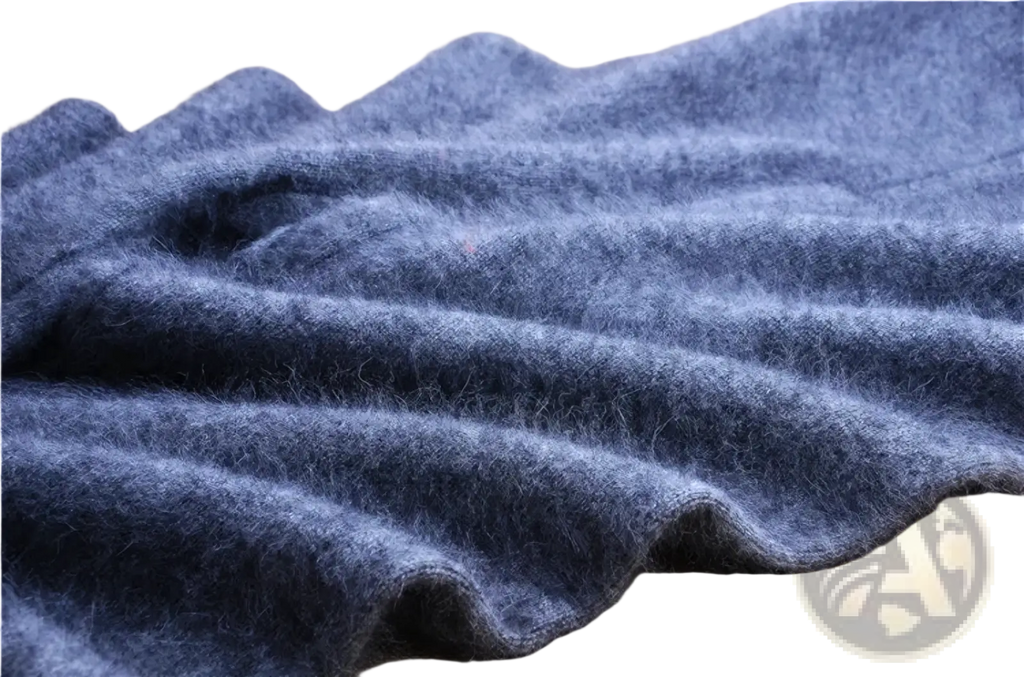 A soft deep blue woolen scarf with a plush texture and folds displayed alongside cashmere knit winter leggings