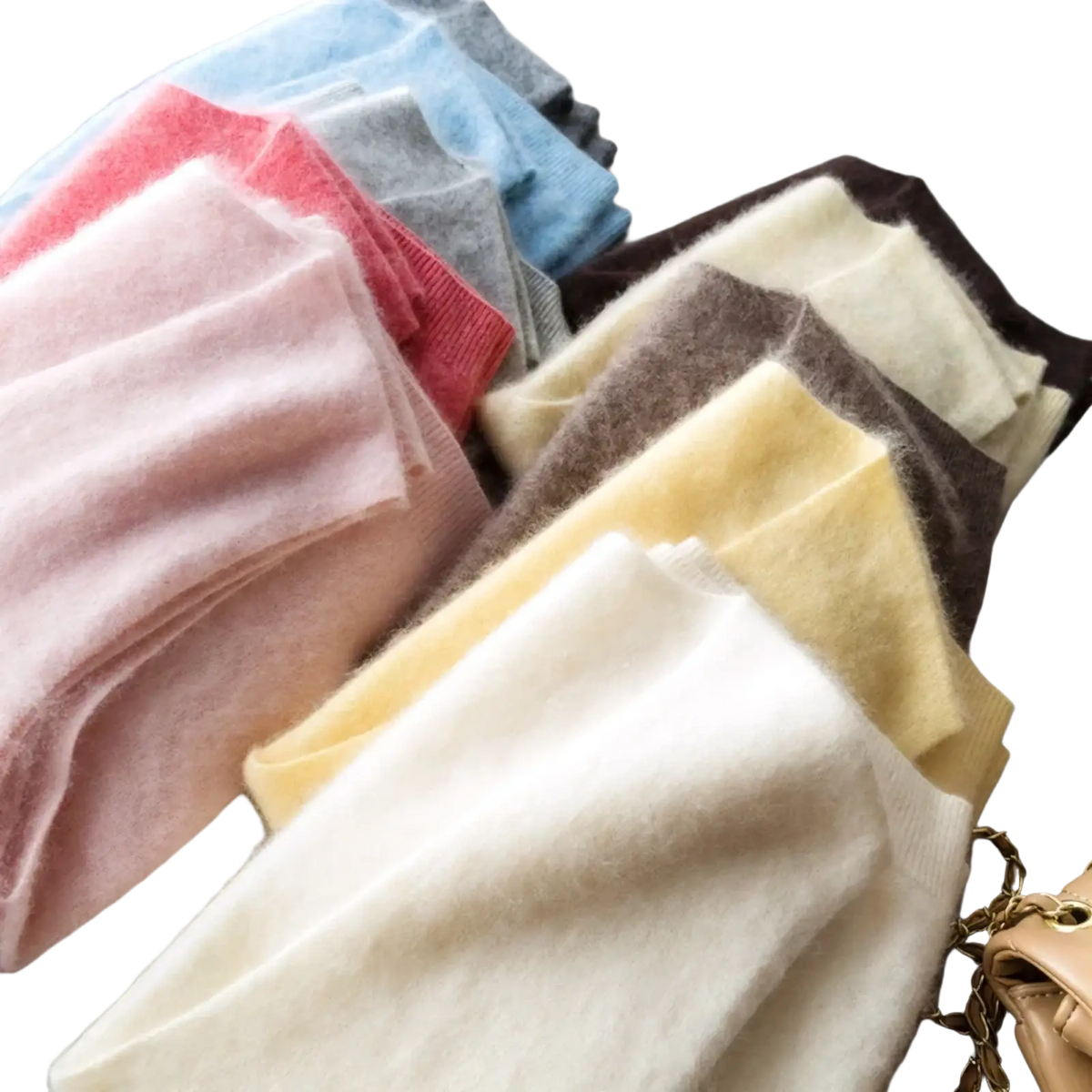 A collection of soft fluffy cashmere scarves in pastel and neutral tones complementing the cashmere wool v neck sweater vest