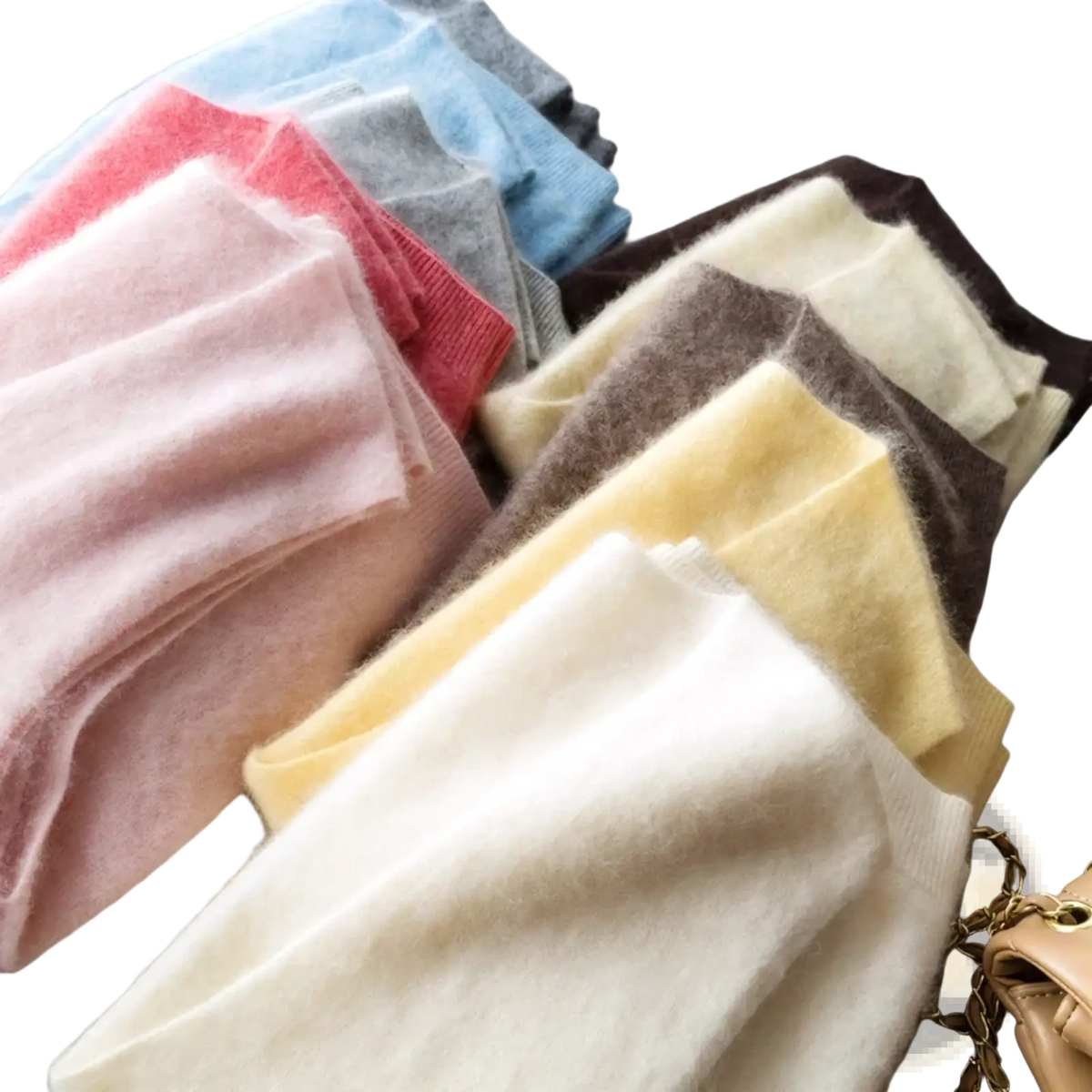 A collection of soft fluffy cashmere scarves in pastel and neutral tones complementing the cashmere wool v neck sweater vest