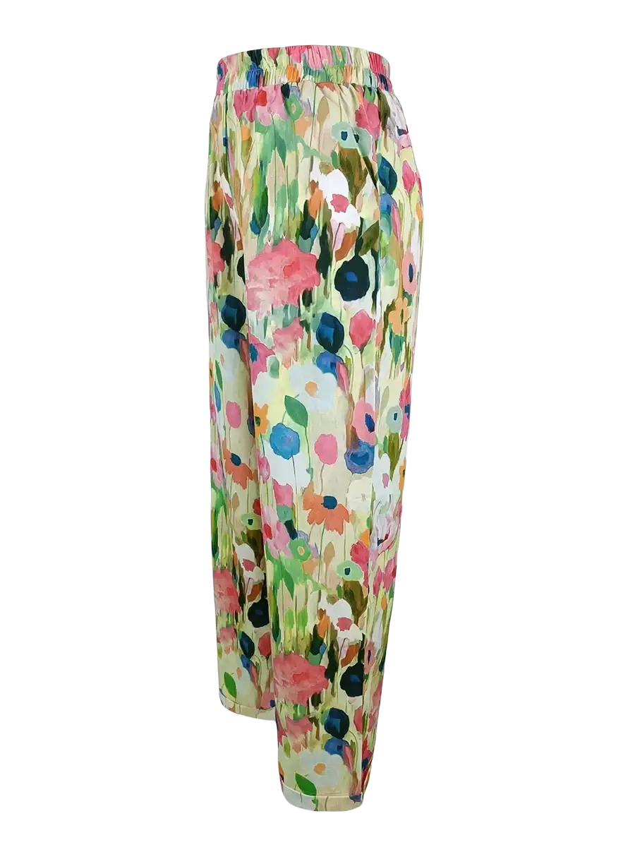 Casual floral print wide leg pants in soft flowing fabric with vibrant pink blue and green blossoms on off white background
