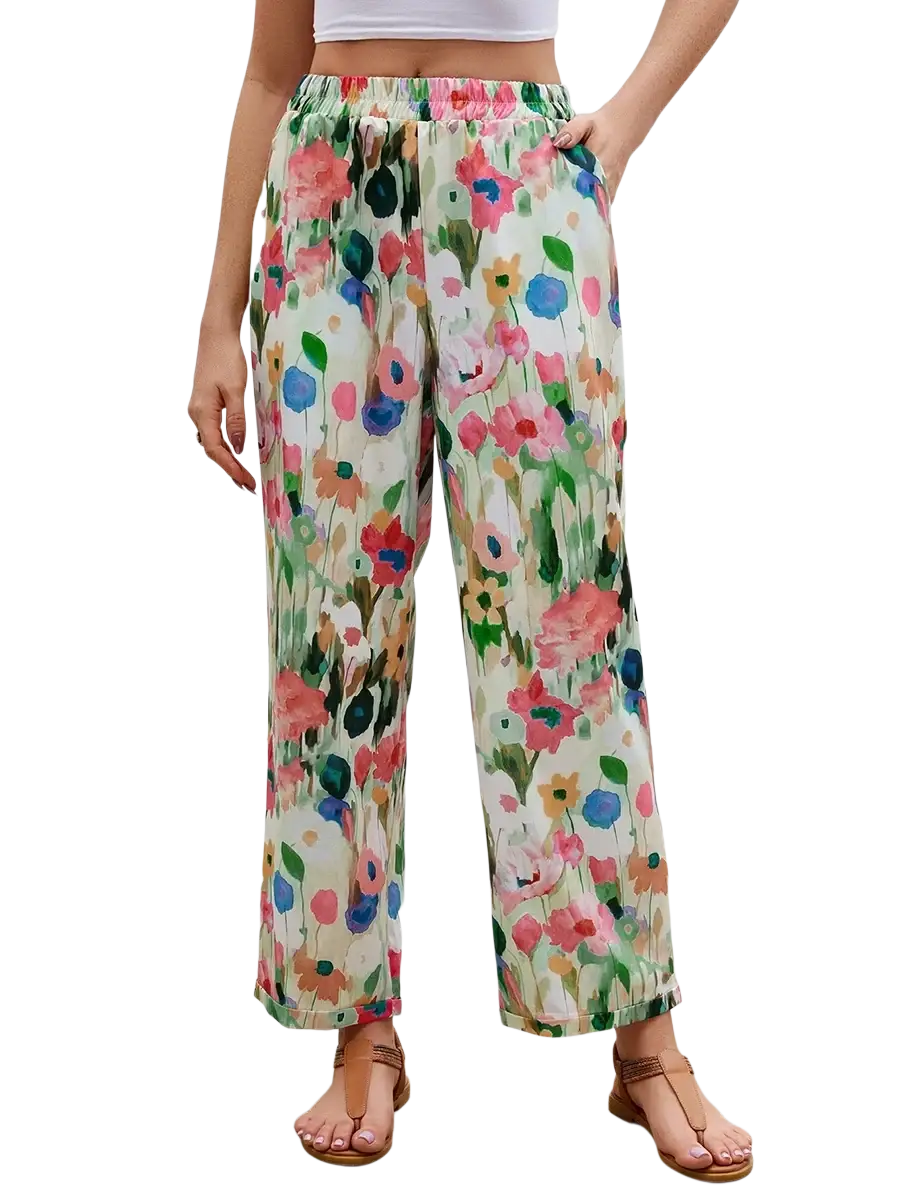 Casual floral print wide leg pants in soft flowing fabric with vibrant pink, blue, and green blossoms on off-white background