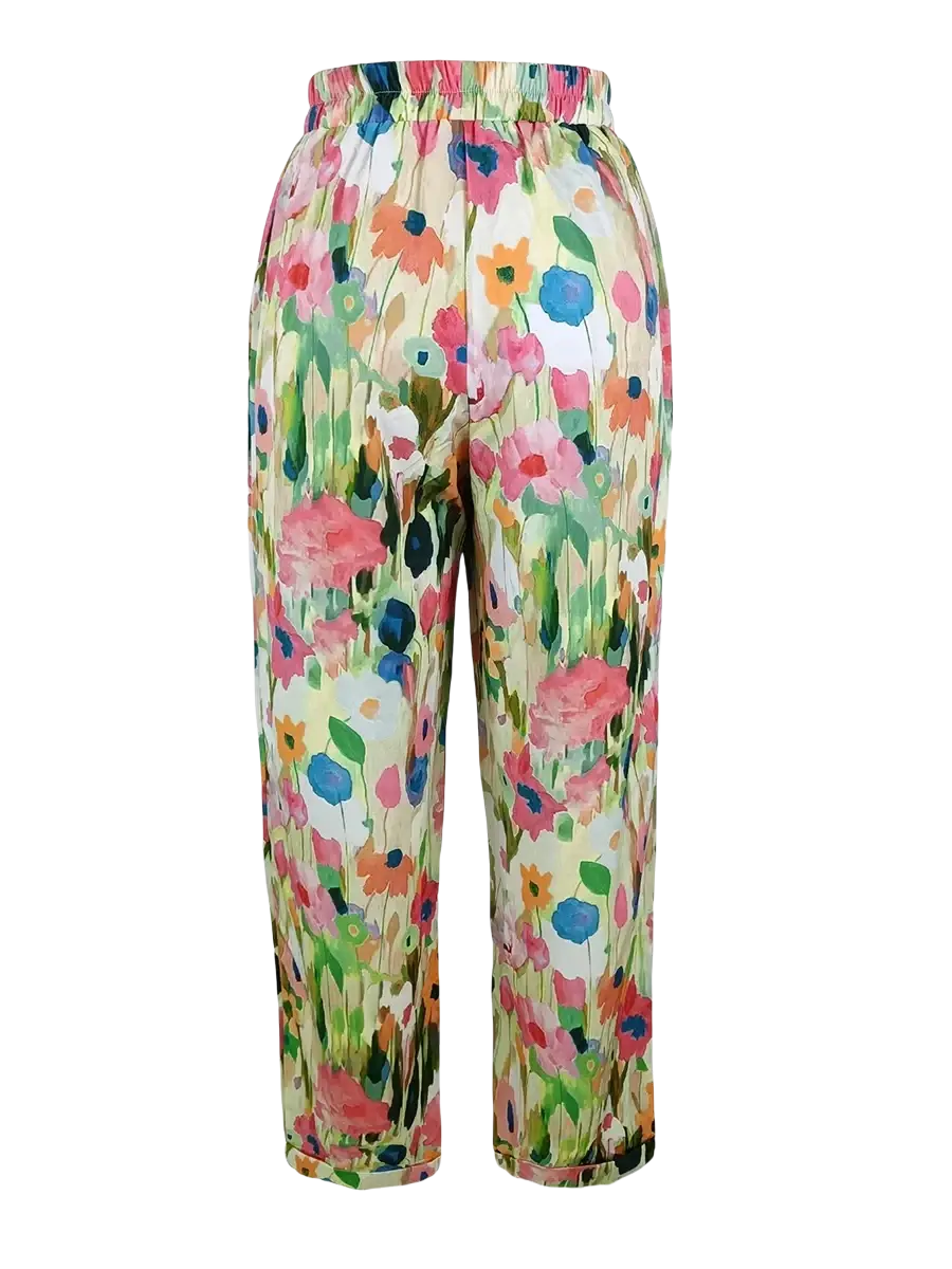 Casual floral print wide leg pants in soft flowing fabric with vibrant pink blue and orange blossoms on off white background