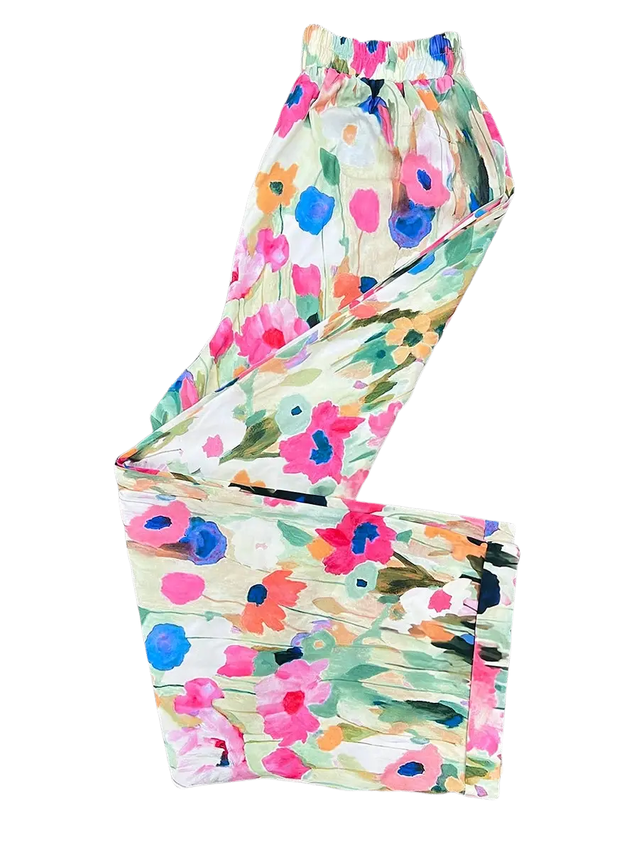 Casual floral print wide leg pants in soft flowing fabric with vibrant pink blue and green blossoms on off-white background