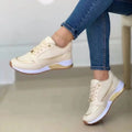 Women’s casual walking sneakers in cream with gold metallic accents and a white midsole featuring a round toe