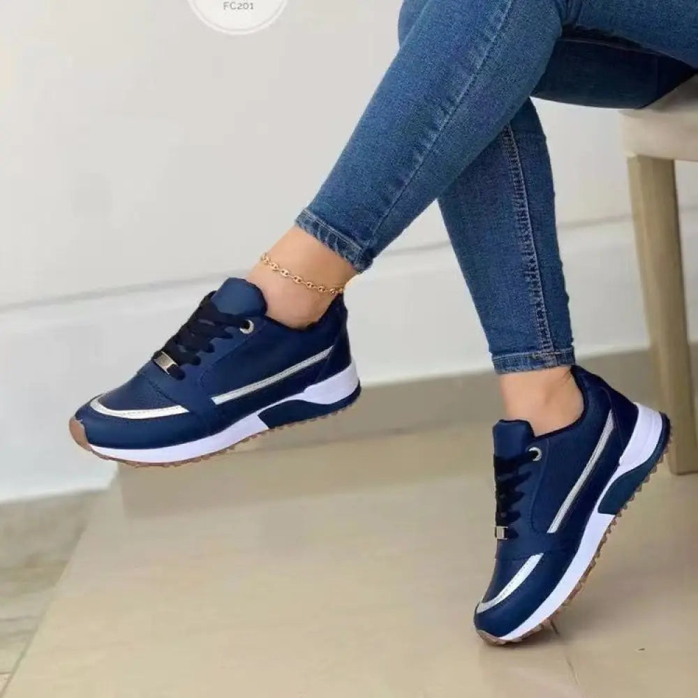 Women’s casual metallic accent round toe walking sneakers in navy blue with white silver side details and textured rubber sole