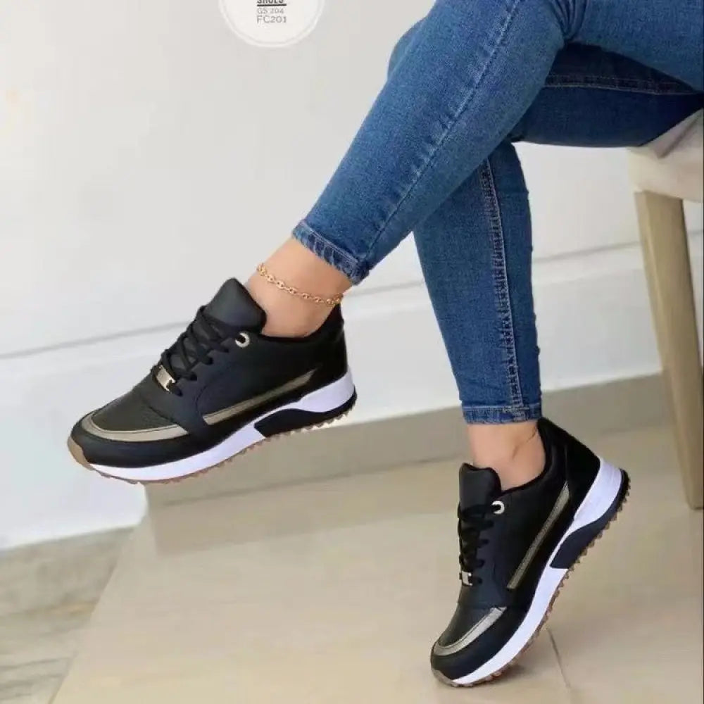 Women’s casual round toe walking sneakers in black and white with silver metallic side accents for athletic use