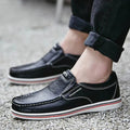 Men’s british leather slip on shoes in black with white stitching and a red and white striped rubber sole