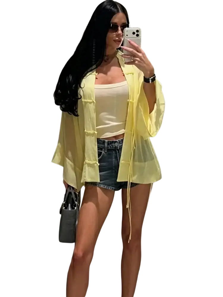 Yellow sheer button-up casual shirt with long sleeves and tie-side details perfect for a light, stylish blouse