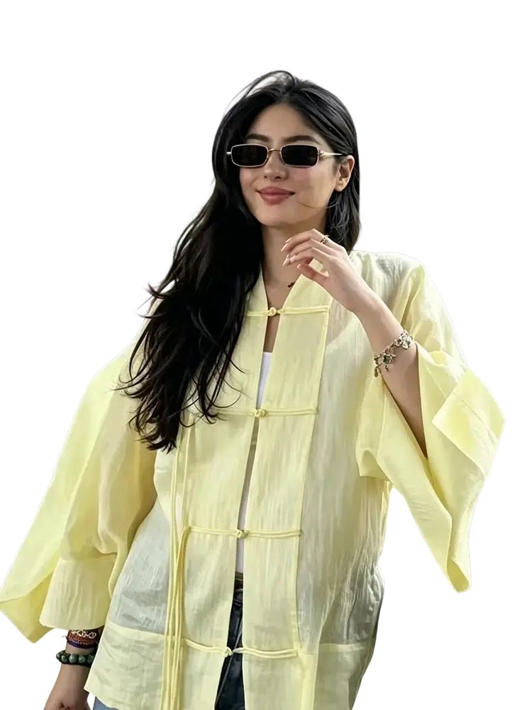 A pale yellow lightweight linen casual shirt with sheer fabric, traditional chinese frog closures, and wide sleeves