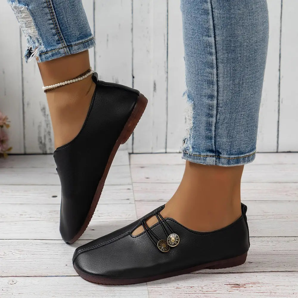 Black leather women’s square toe loafers with button details and brown sole slip-on flats