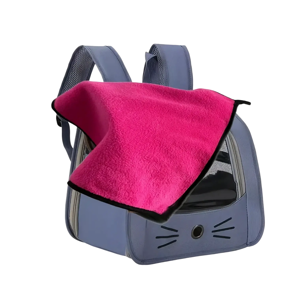 A gray cat-themed portable pet carrier backpack with a pink fleece blanket draped over the top for comfort