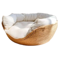 Cozy round cat bed sleeping bag with woven paper rope exterior and plush white cushioning for comfortable rest