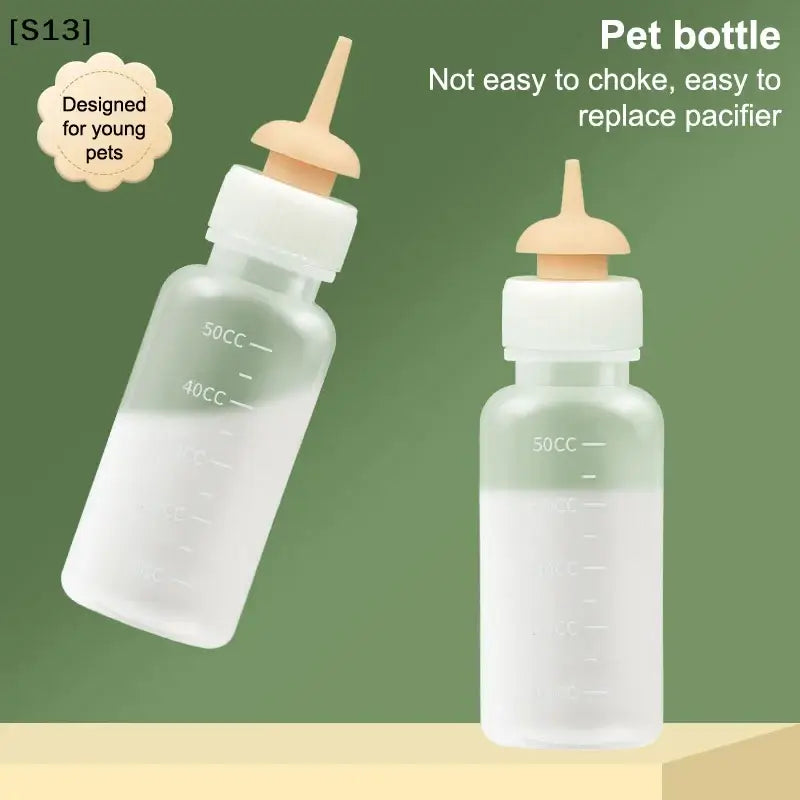 Transparent plastic cat bottle feeder with white screw cap beige silicone nipple and measuring scale for newborn pets