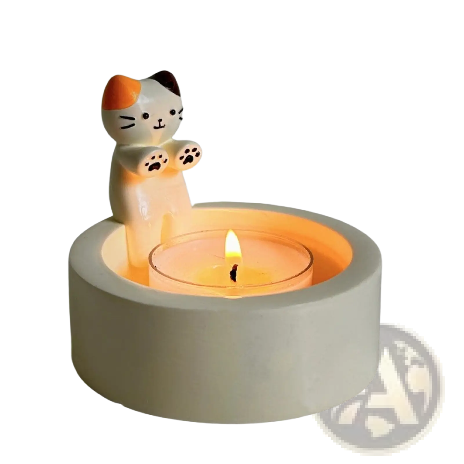 Cute ceramic cat candlestick holder with orange and black markings holding a lit tea light in its paws