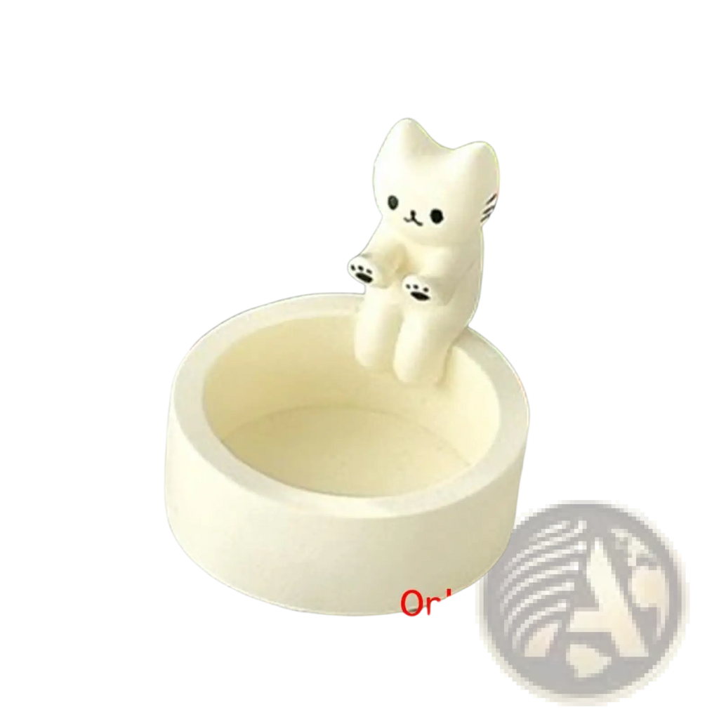 White ceramic candlestick holder with a sitting cat figurine on the rim for tea light candles