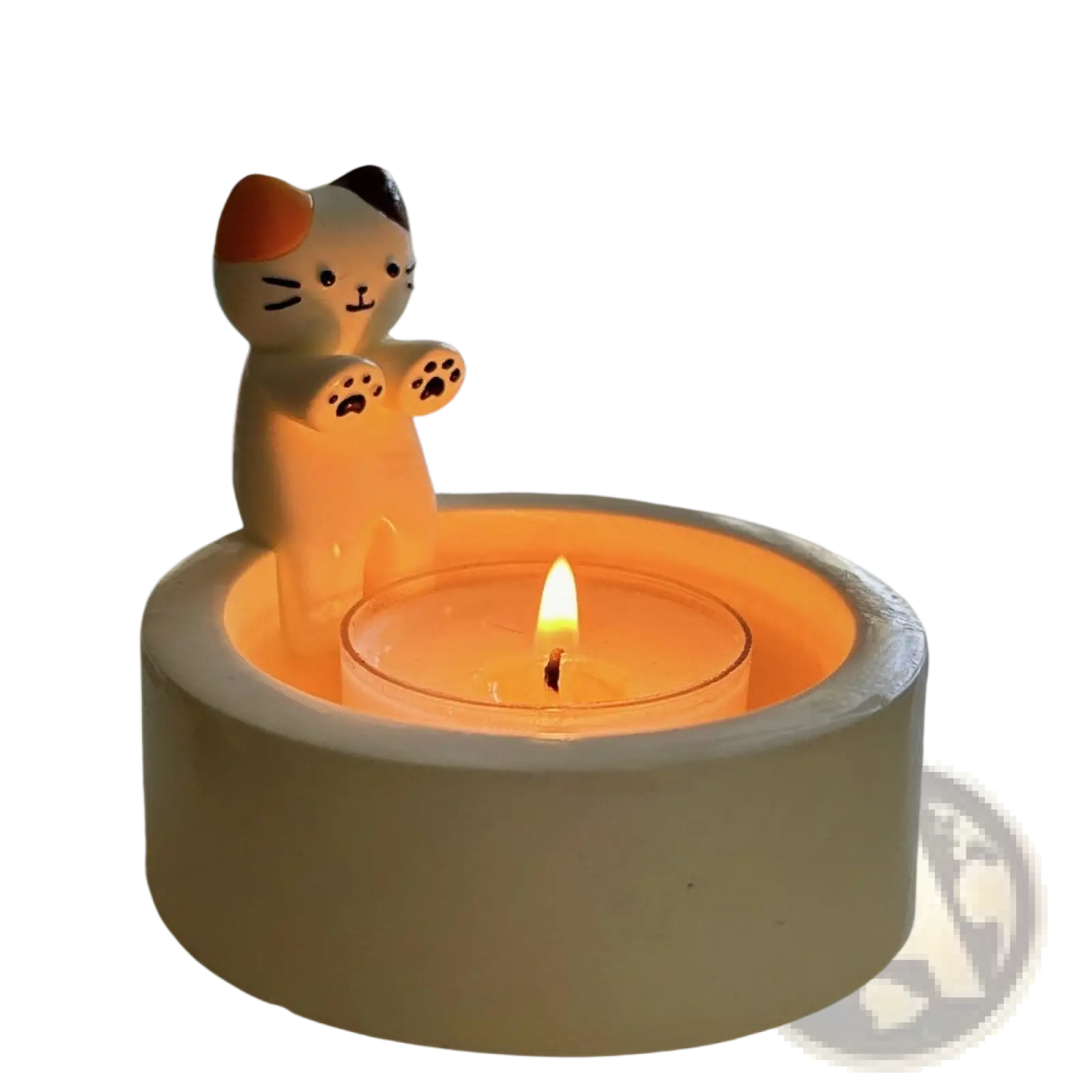 Cute calico cat ceramic candlestick holder with orange black and white markings holding a lit tealight candle