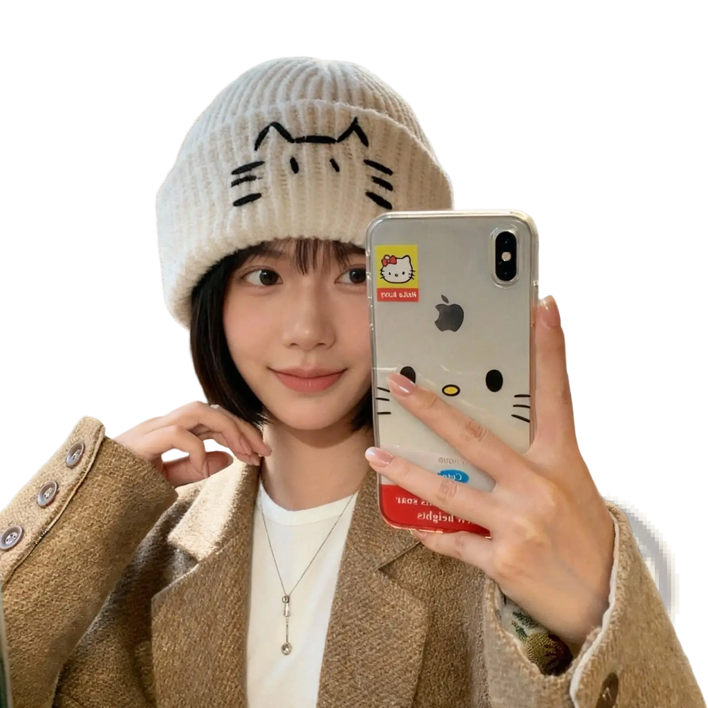 Cream-colored knitted beanie hat with a black embroidered cat face design perfect for casual wear
