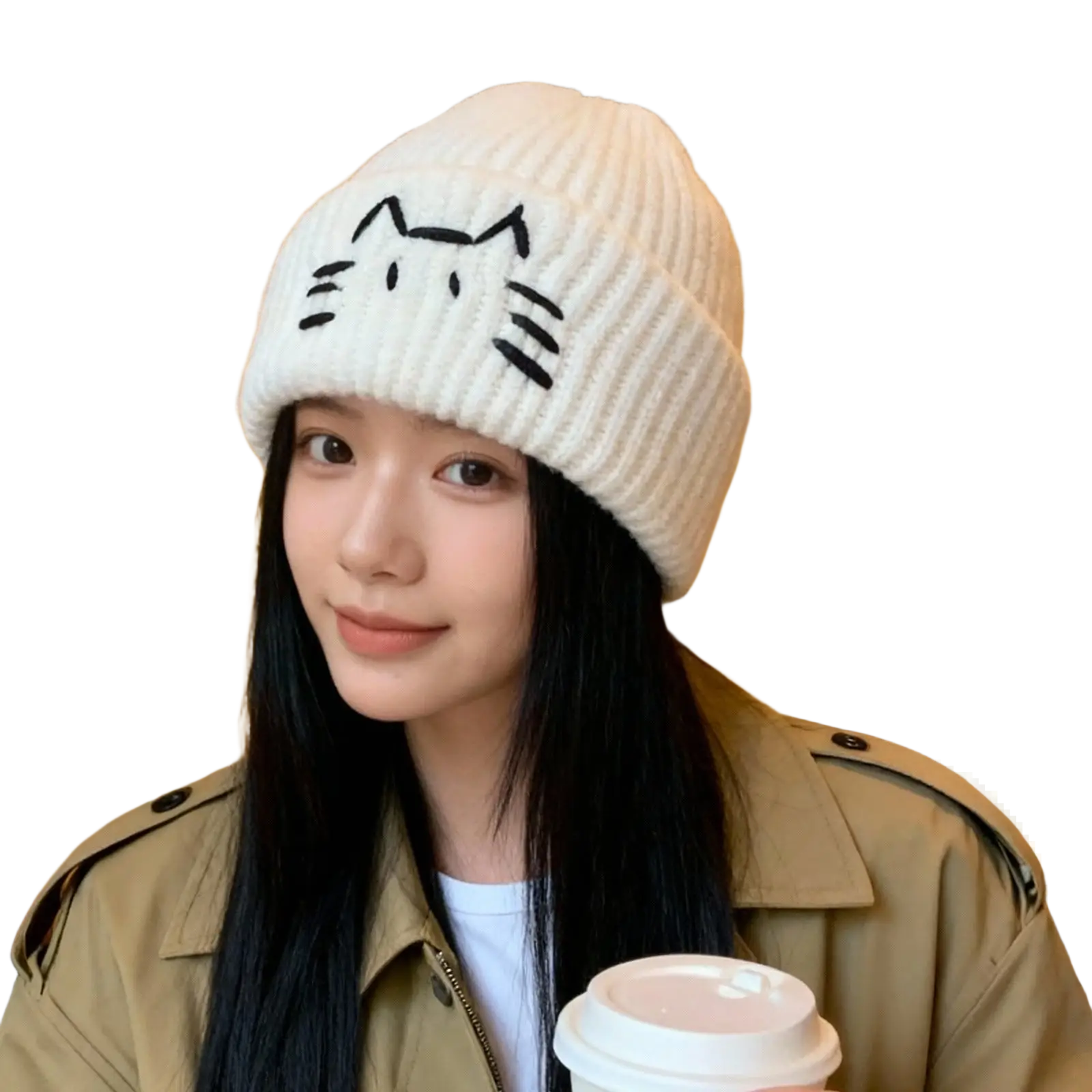 A cream-colored knitted beanie hat with a black embroidered cat face design