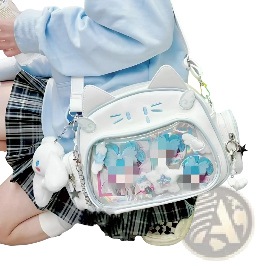 White cat-shaped crossbody bag with clear ita panel and plush accessories ideal for casual use