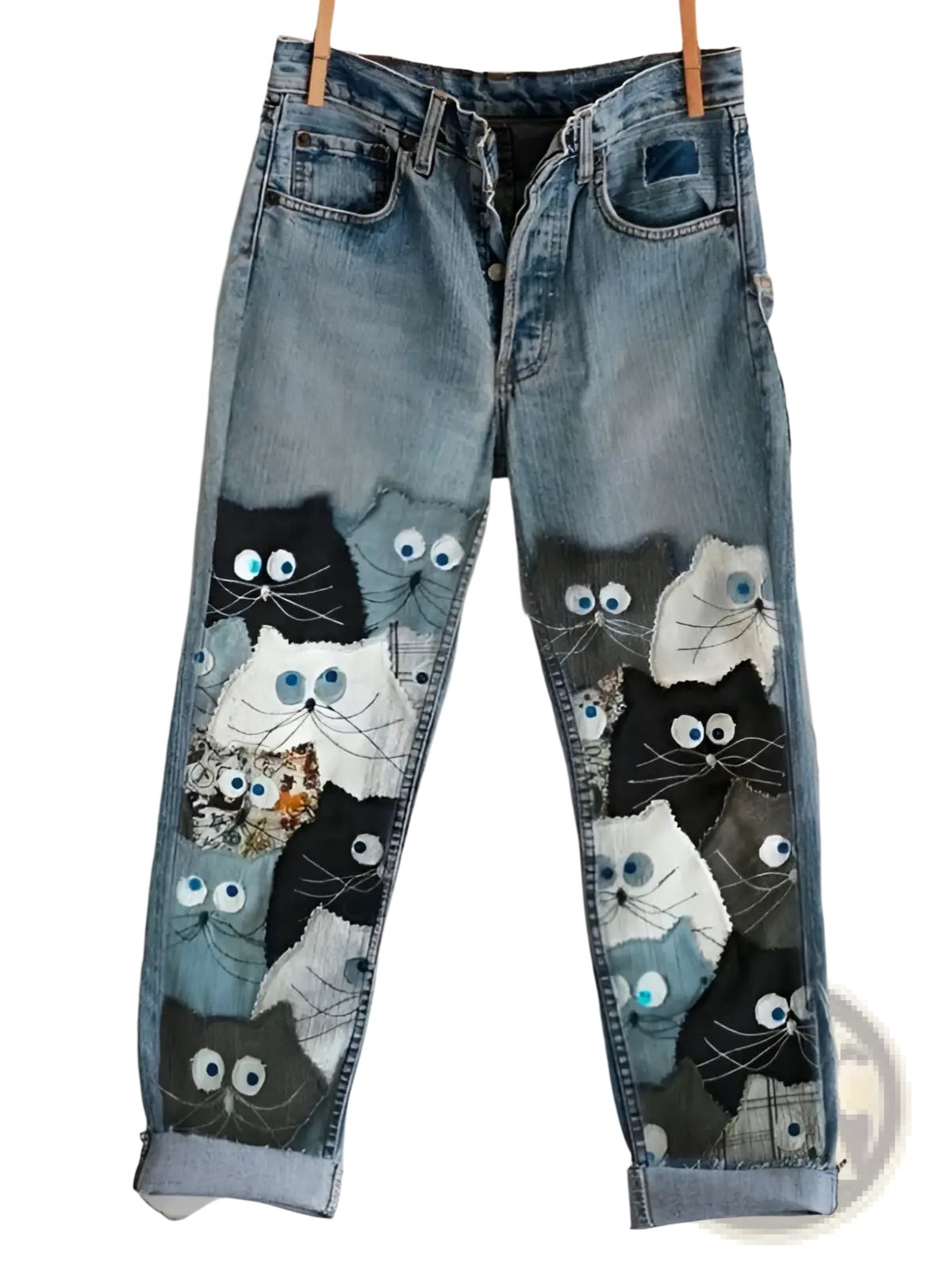 Blue denim faux denim flared trousers featuring a colorful patchwork of embroidered cat faces on the front side