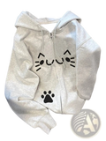 A soft heather gray zip up hoodie with a warm kawaii black cat face and paw print design