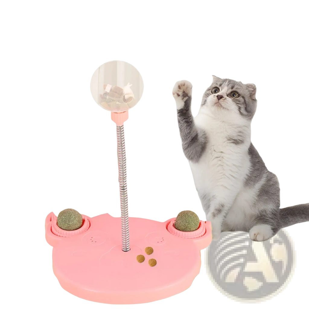 Pink cat-shaped interactive cat puzzle toy tumbler food dispenser with clear ball on metal pole and green textured balls