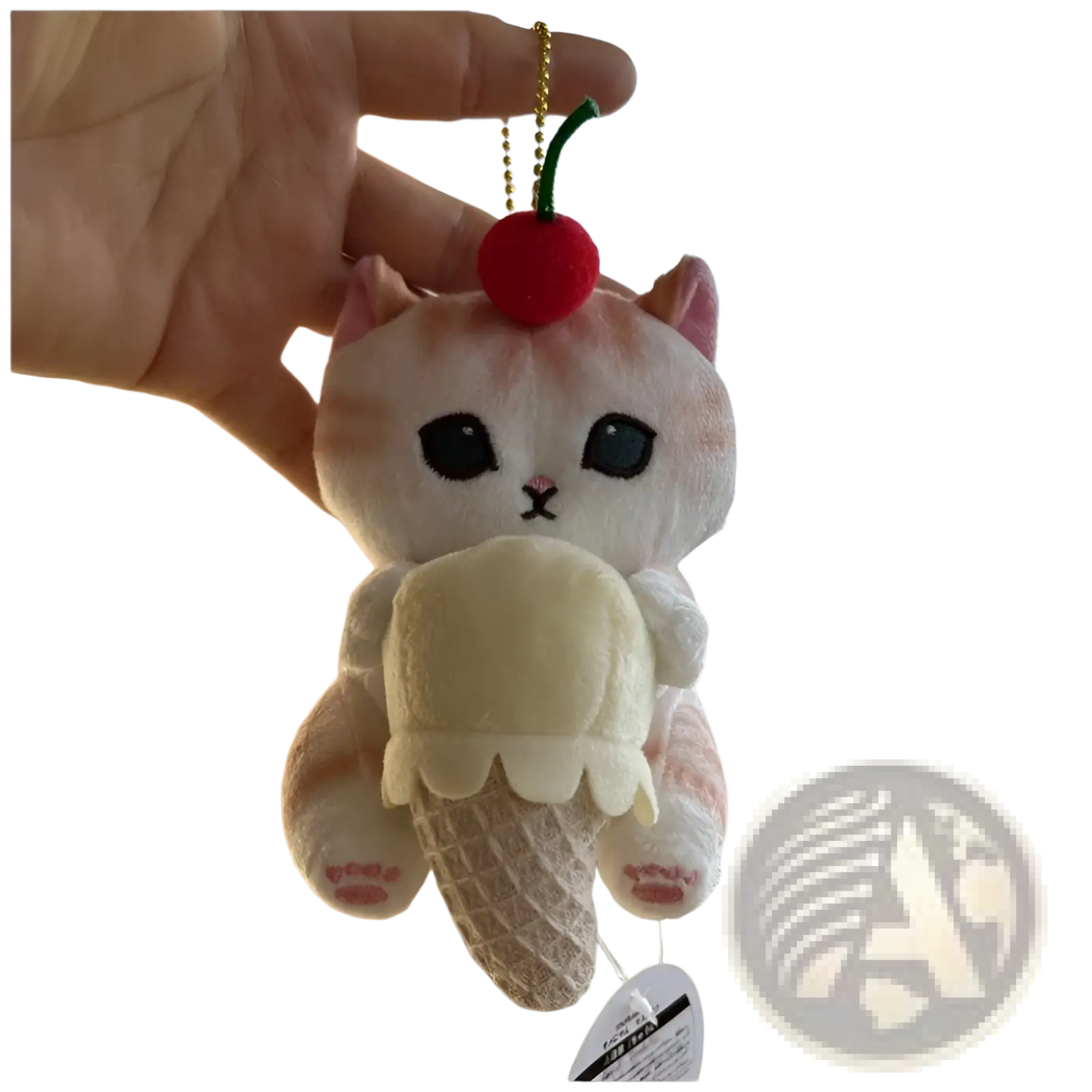 A soft plush cat shark keychain with a cream body and pink accents holding an ice cream cone with a red cherry