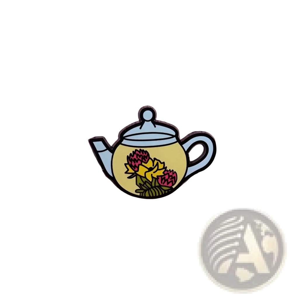 Yellow enamel cat witch teapot pin with pink and yellow flowers, light blue lid and handle, whimsical copper brooch