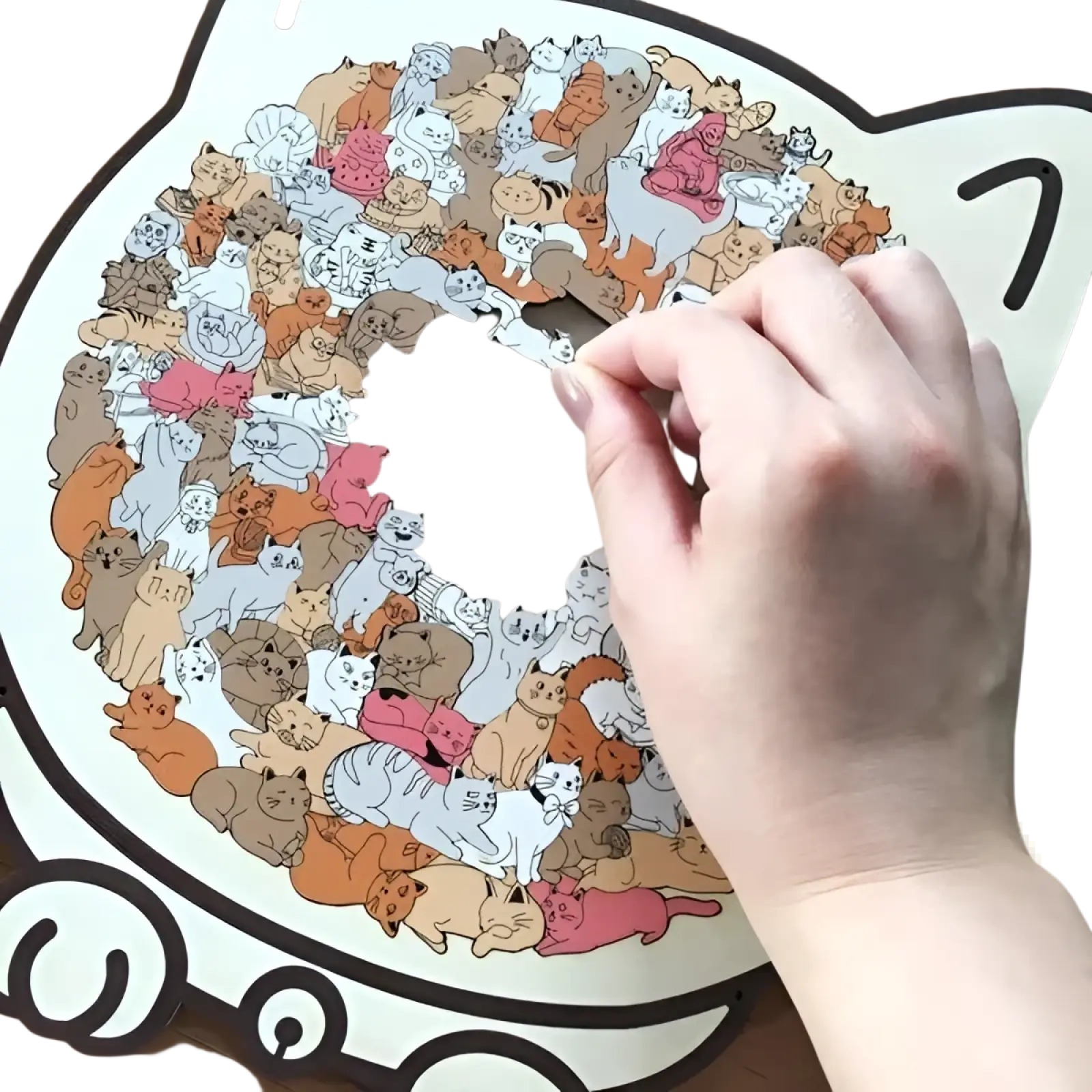 A hand places a cat-shaped wooden piece onto a circular colorful cat-themed morandi jigsaw puzzle with 135 pieces