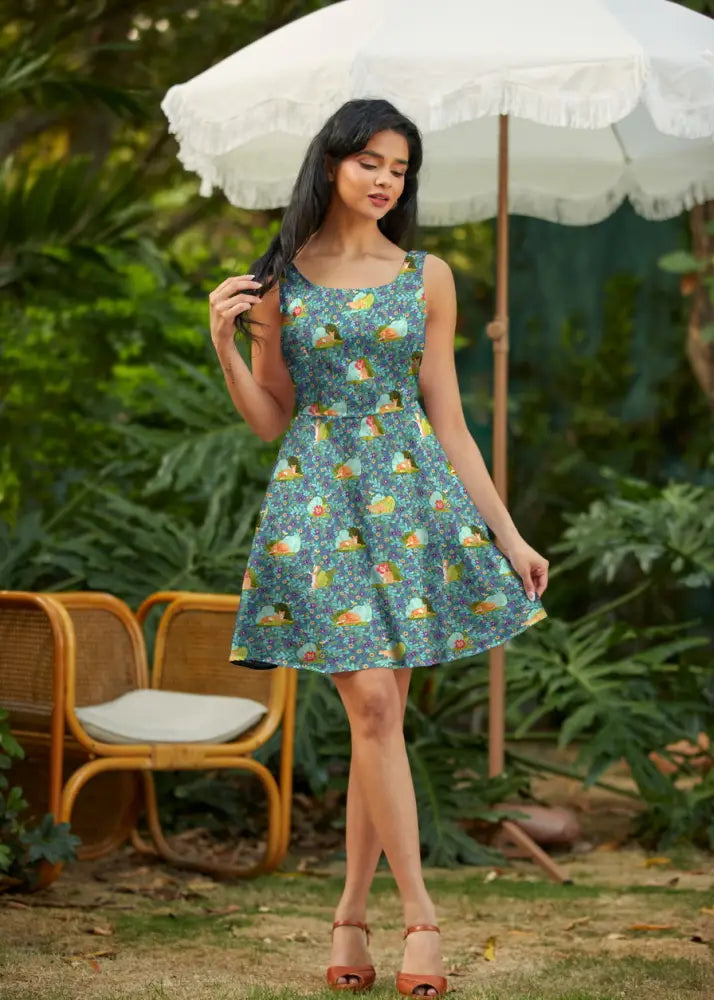 Teal floral cat print sleeveless skater dress with square neckline pockets and playful cartoon character motifs