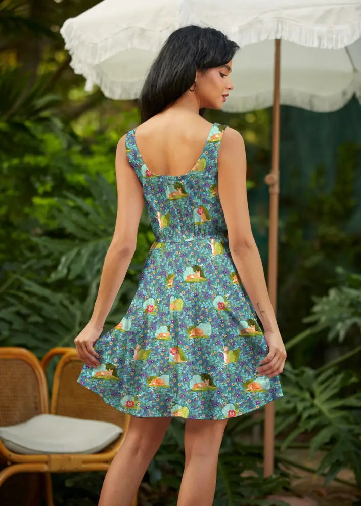 Teal floral cat print sleeveless skater dress with pockets featuring a fitted bodice and flared skirt with fairy illustrations