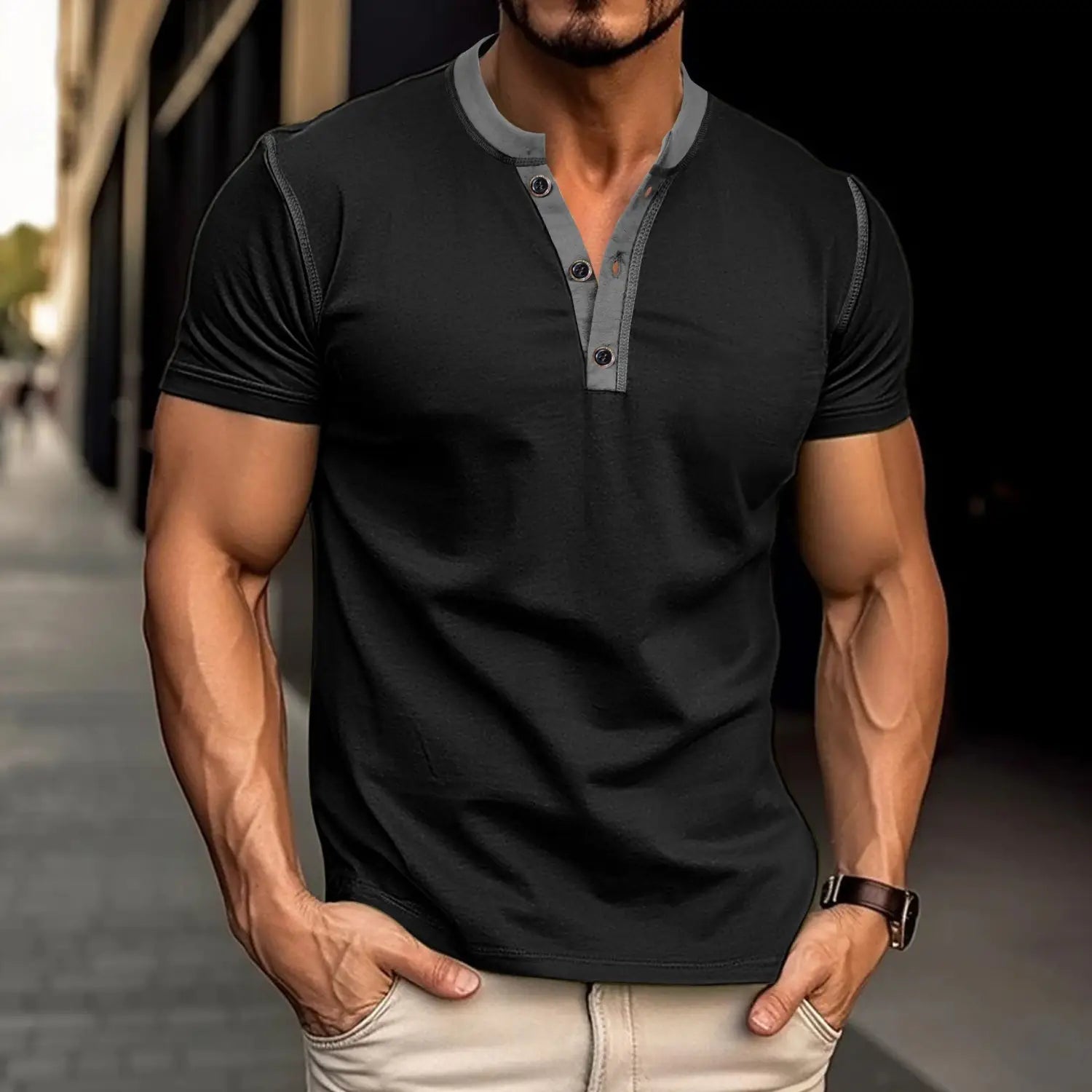 Black short-sleeved henley polo shirt featuring a gray button placket and contrast trim, ideal for casual wear.