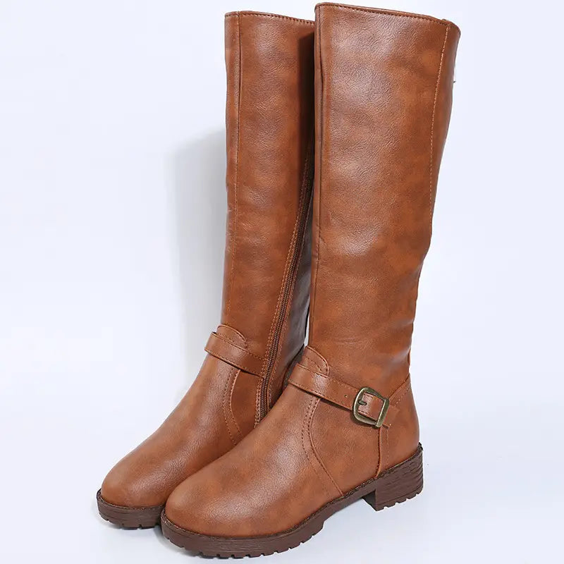 brown leather knee high knight boots featuring a buckle strap and low block heel
